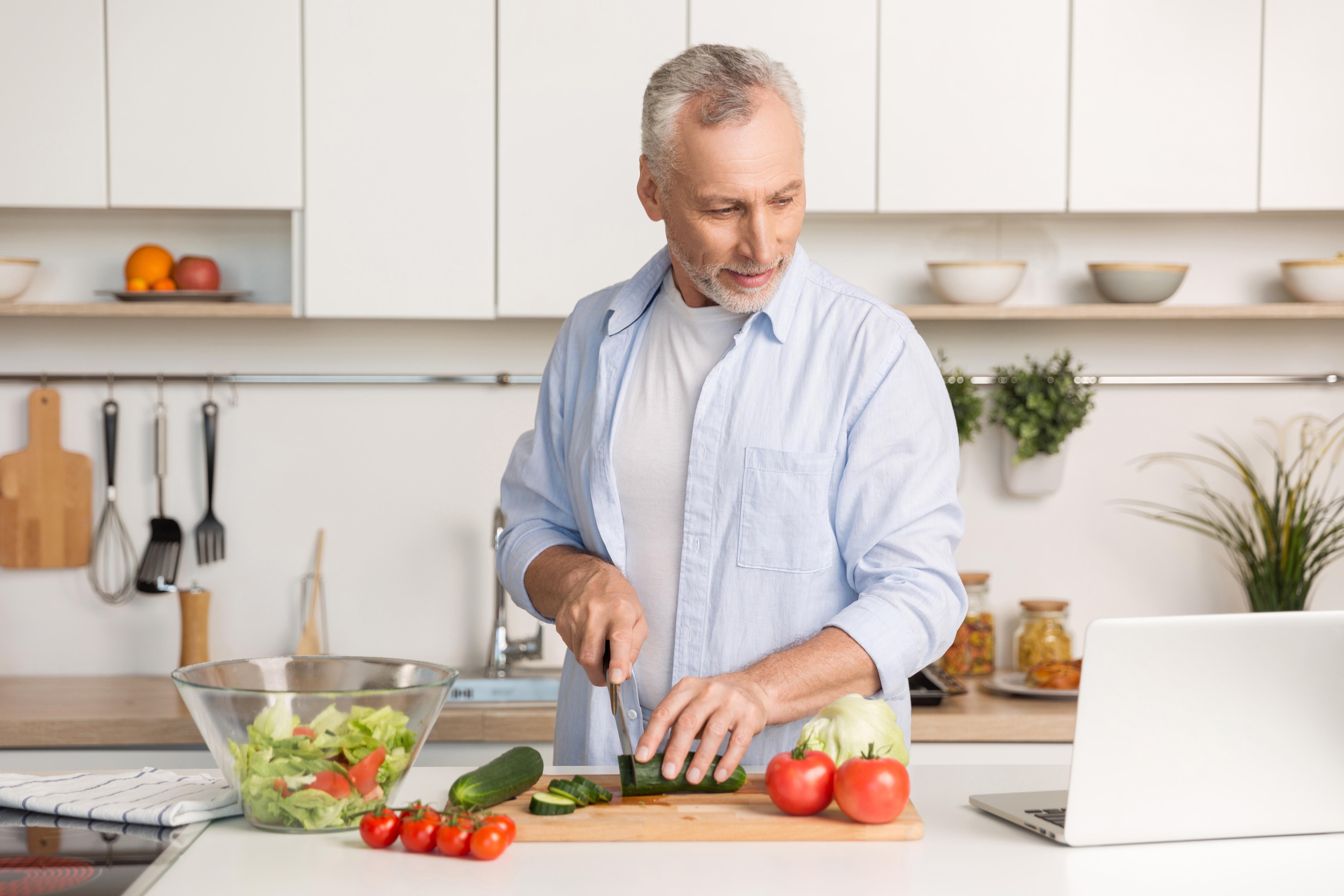 man cutting vegetables